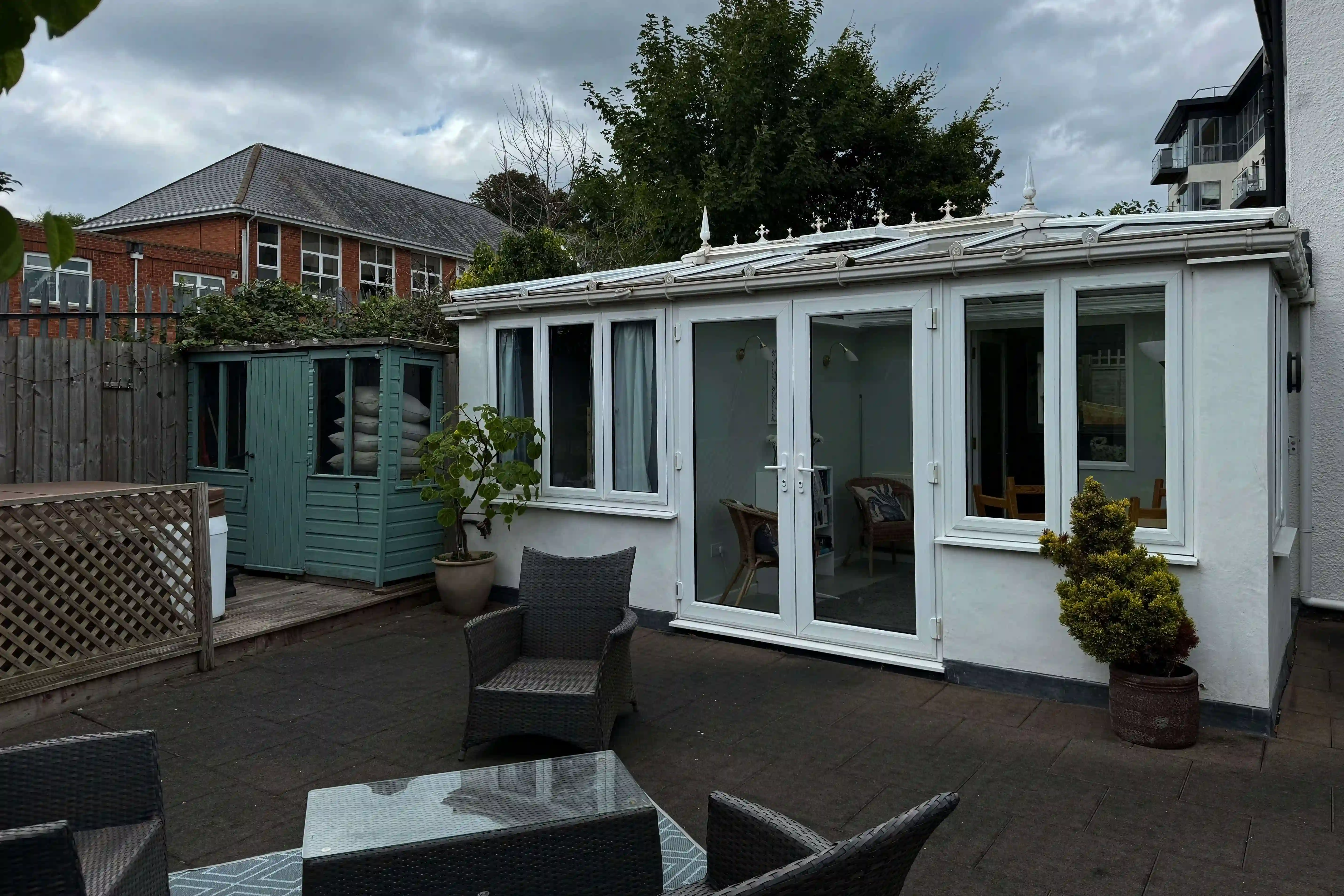A poor photo of a house, with grey skies and poor focus